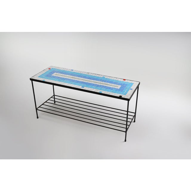 Vintage mosaic coffee table with a sturdy black metal frame and ceramic tile top. The small ceramic tiles in vibrant bleu,...