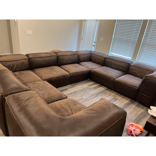 This couch was previously in the World Congress building in Georgia. Well loved, Super Comfy This will need to be restored