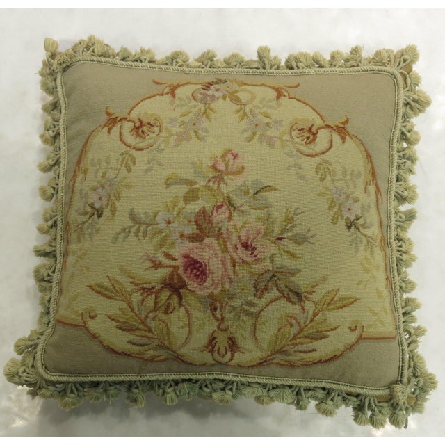 Authentic stand alone pillow made from a 19th century French Aubusson rug with a floral motif with green tasseled corners....