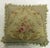 Authentic stand alone pillow made from a 19th century French Aubusson rug with a floral motif with green tasseled corners....