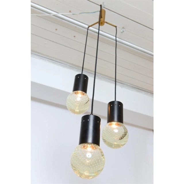 Chandelier with three glass globes. Lovely speckled light reflected through glass globes. Chandelier can be adjusted to...