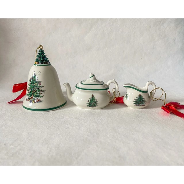 Set of three vintage Spode Christmas tree ornaments, including a porcelain bell with a resin Christmas tree on top and a...