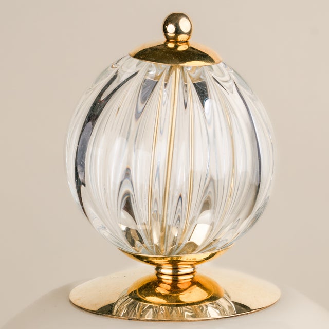 This sophisticated table lamp combines a minimalist, organically inspired silhouette with details reminiscent of fine...