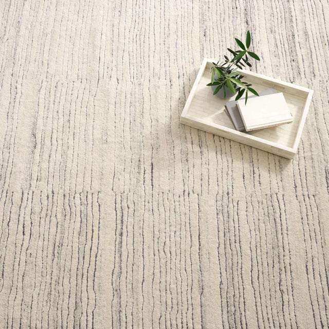 Inspired by substrate layers of sandstone sediments that chronicle the millennia, this luxurious, irregularly striped wool...