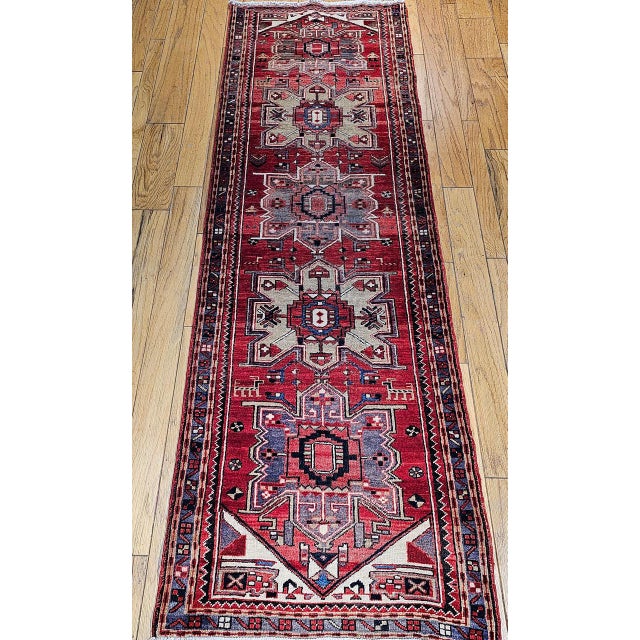 "This striking vintage Persian Heriz runner, woven in the second quarter of the 20th century, features a classic geometric...