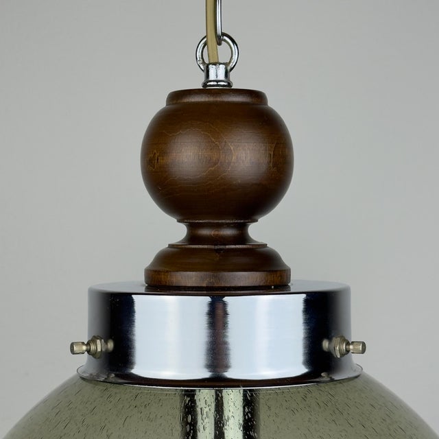 The rare hand-blown murano glass pendant lamp made in italy in the 1960s. a transparent glass shade with a "pulegoso"...