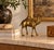Beautiful vintage 1980s brass camel sculpture featuring an elegant, sculptural silhouette with a single hump, elongated...
