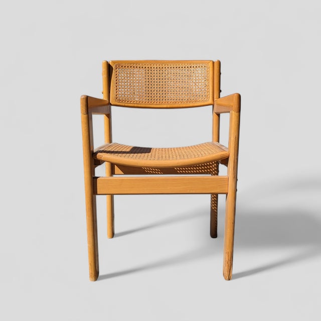 A refined mid-century accent chair combining the warmth of birch with the airy texture of cane. Its compact footprint...