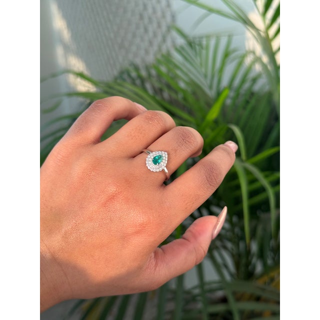 This statement ring features a 0.43 carat pear-cut natural emerald set in 14K white gold. The center stone measures...