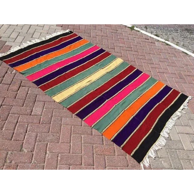 This beautiful, traditional vintage, flatweaved Turkish kilim rug is approximately 60 years old. It is handmade of very...