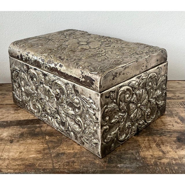 This exquisite vintage metal box showcases the dramatic artistry of traditional repoussé, featuring intricate high-relief...