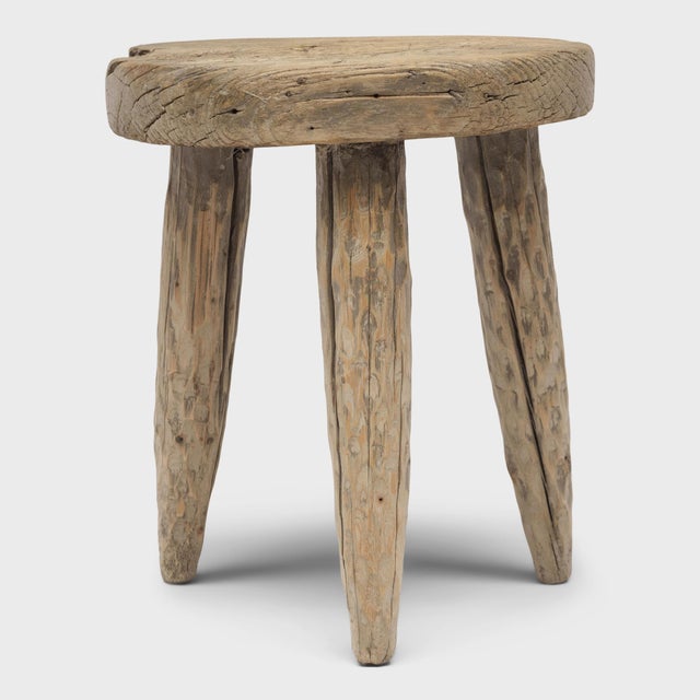 The round top of this rustic, tri-leg side table is an antique wooden cart wheel, repurposed from an early 20th century...