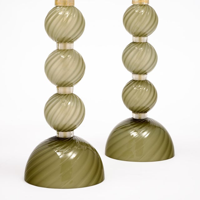 Pair of lamps of Murano glass from Italy. These lamps feature spheres of swirling hand-blown glass on a glass base in a...
