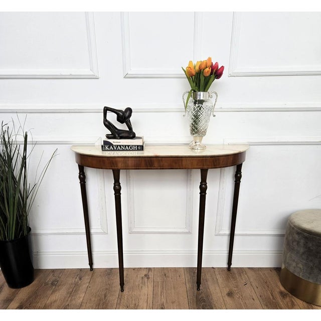 Very elegant and refined Italian 1950s Mid-Century Modern and neoclassical design console table. The four stunning carved...