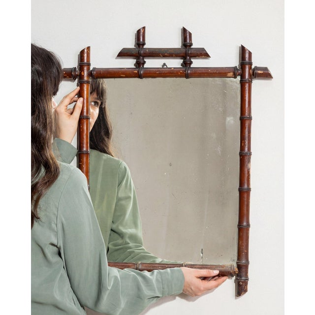 This mirror carries genuine presence, its faux bamboo, dark brown wood immediately setting the tone for the piece. Dating...