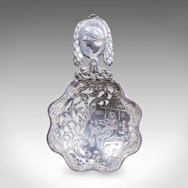 This is a small antique sugar casting spoon. A Dutch, 930 silver sifter with London import hallmarks, dating to the late...