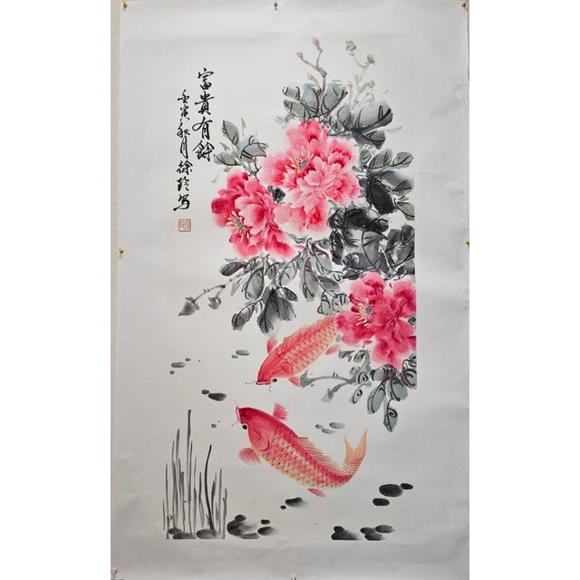 “Fu Gui You Yu” (富贵有余) is an original Chinese ink and color painting on paper, featuring lush blooming peonies and two...
