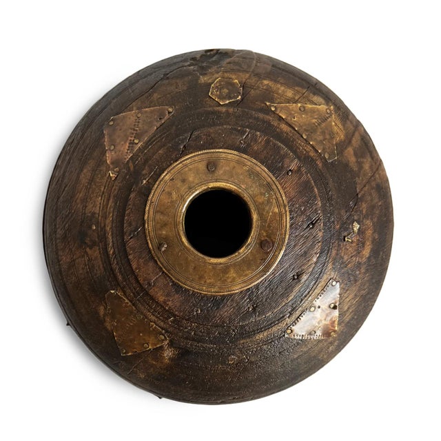 Antique old wooden tobacco container from India. Adorned with brass / metal decorative details. Each is unique and sold...