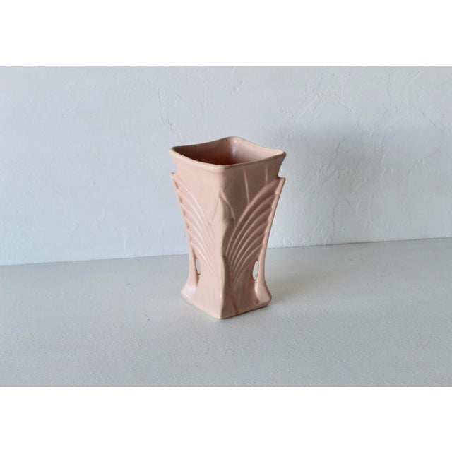 Vintage McCoy Art Deco Wing Vase from the 1940s, featuring a matte rose pink glaze, flared winged sides, and a square rim....