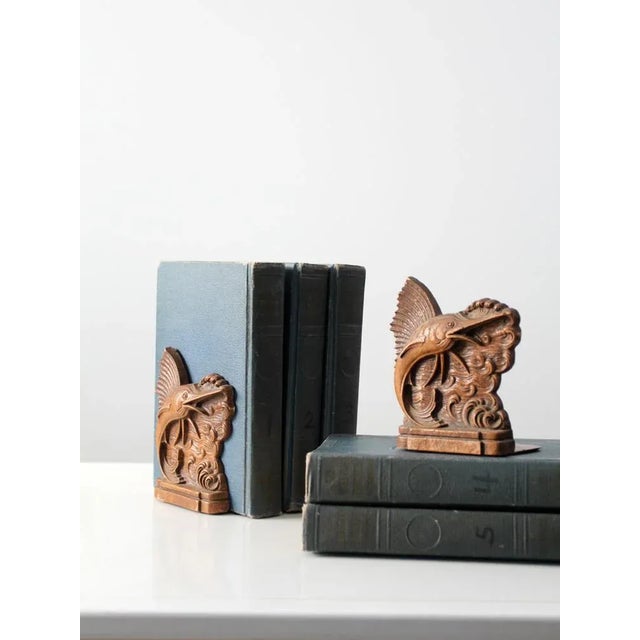 Vintage Syroco-style bookends featuring a dynamic sailfish leaping through sculpted ocean waves. Dating to the 1940s, this...