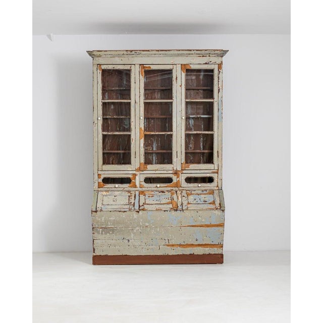 The unusual shape and evocative patina of this antique wooden vitrine makes it a find to treasure. Built in Portugal in...