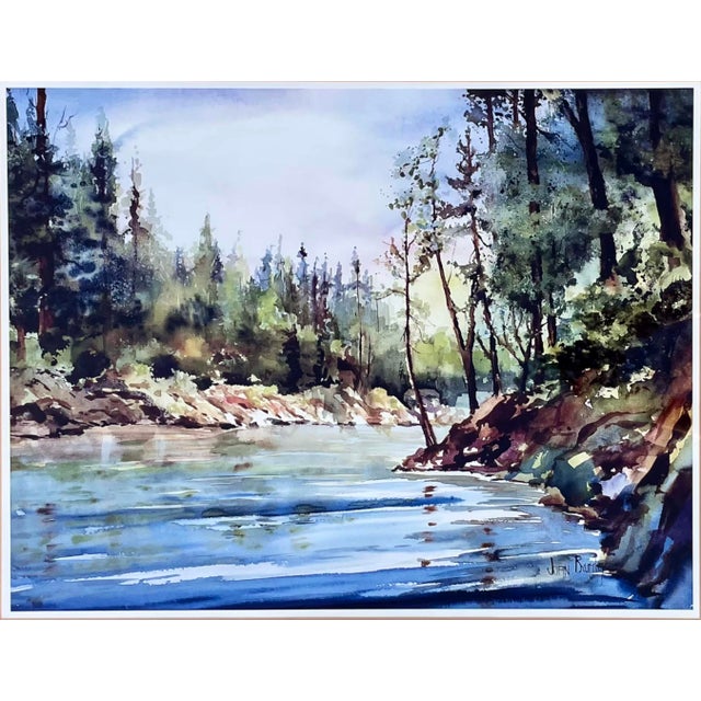Framed by tall evergreens and sunlit rocks, a quiet river bends in this serene watercolor landscape by Joan Brumley. Its...