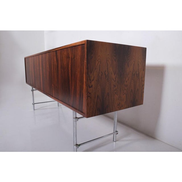 Very rare freestanding sideboard model INFI made of Rosewood and a chromed steel base Designed by Jan Lunde Knudsen and...