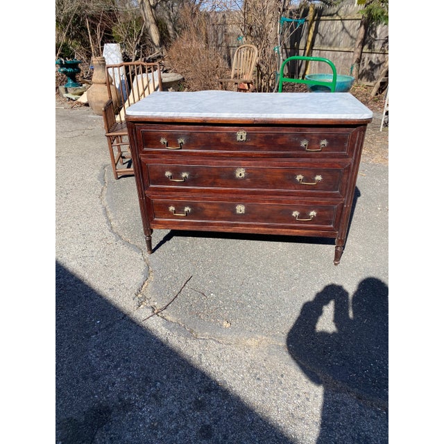 Neoclassical Italian Marble Top Commode. Three drawers with carved fluted columns. Starburst brass hardware. Original Rich...