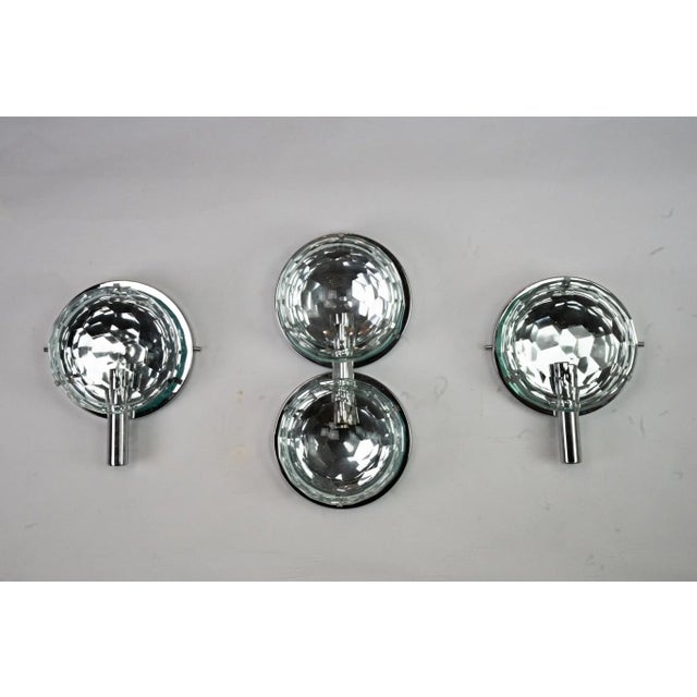 This set includes three mid-century Italian wall sconces designed by Cristal Art in the 1970s. The central piece features...