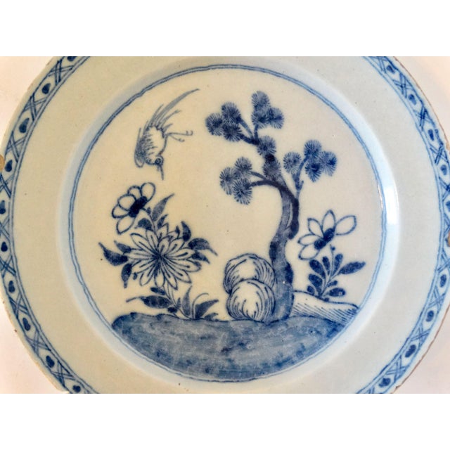 An early large English Delftware faience charger hand painted with a chinoiserie design. This lovely charger is hand...