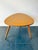 This large triangular coffee / side table features a mid-century modern design with a formica-covered top and tapered...
