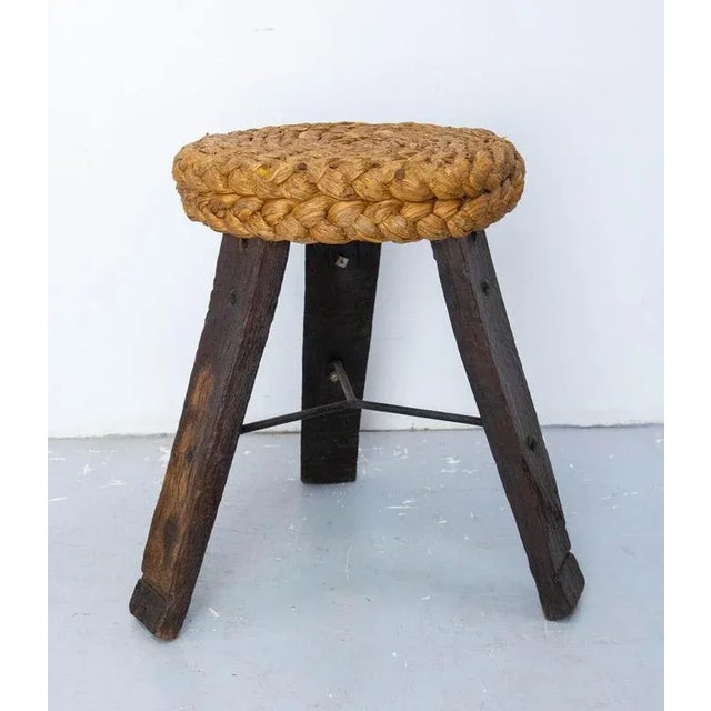 Vintage french three legs stool in massive oak and woven straw. The legs are made with wood from barrels. The design duo...