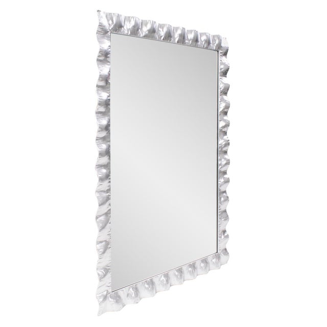 This mirror features textured frames that mimic the undulating patterns of waves, adding a touch of fluidity and movement...