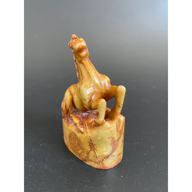 Presenting a vintage Chinese stone carving seal. The elliptical cylinder shaped seal features a finely carved horse on the...