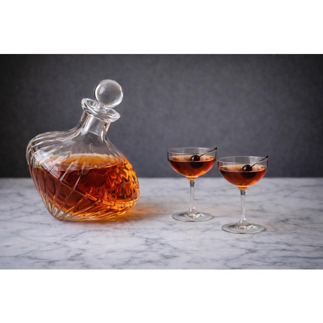 Like a crystal top frozen mid-spin, this sculptural 1990s decanter brings a playful sense of movement to the bar. The...