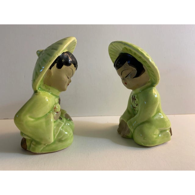 Charming set of a boy and a girl in green outfits and hats. Salt and pepper. Corks in the bottoms.