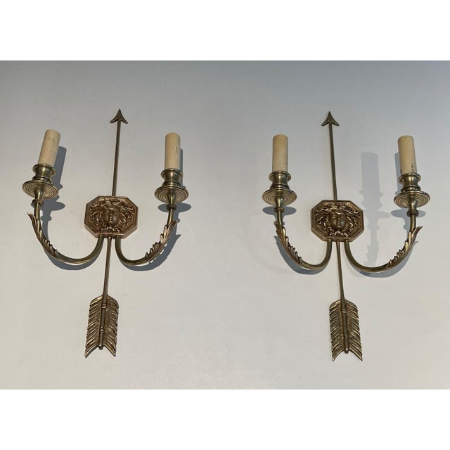 Pair of bronze wall sconces with Arrows and Effigy of the Sun King by Louis Gau