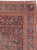 An antique Persian Bidjar rug from the early 20th century. The wine red small Herati pattern field is overlaid by a light...