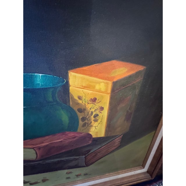 A handsome large-scale vintage still life painting featuring a richly layered arrangement of antique books, fruit,...