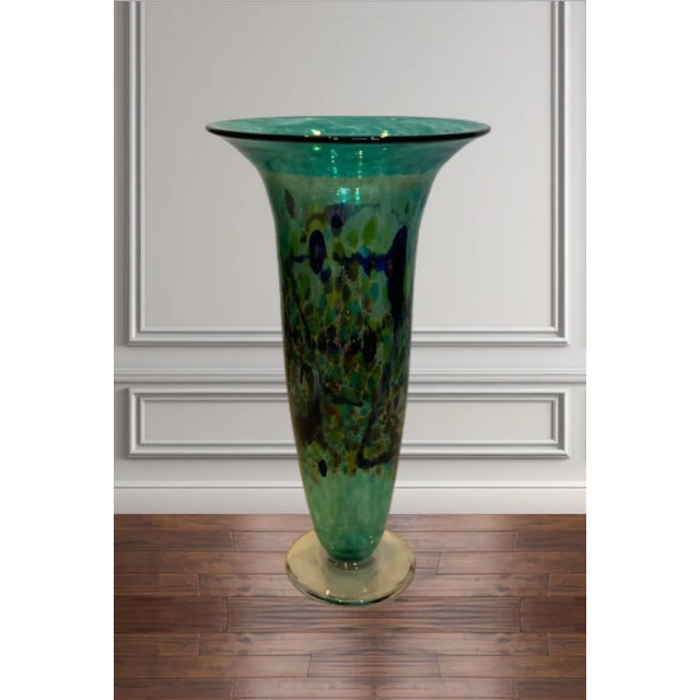 This striking 13.5-inch tall trumpet-shaped art glass vase, crafted by renowned Canadian glass artist Robert Held, is a...