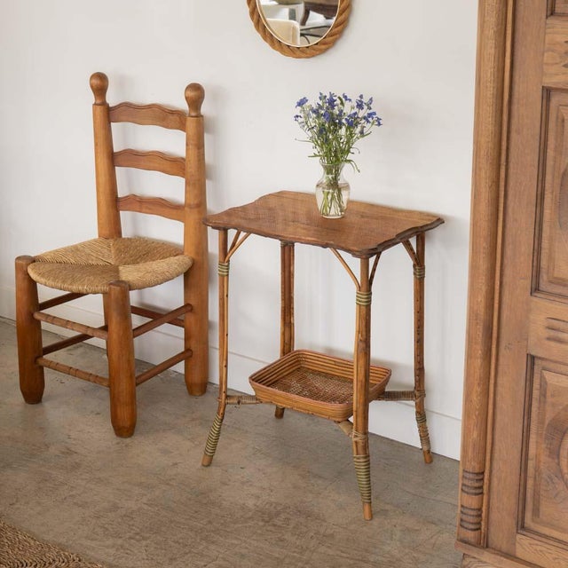 Beautiful 1950s wood and wicker table from France. Original scalloped rectangular wood top with stepped edge detail....