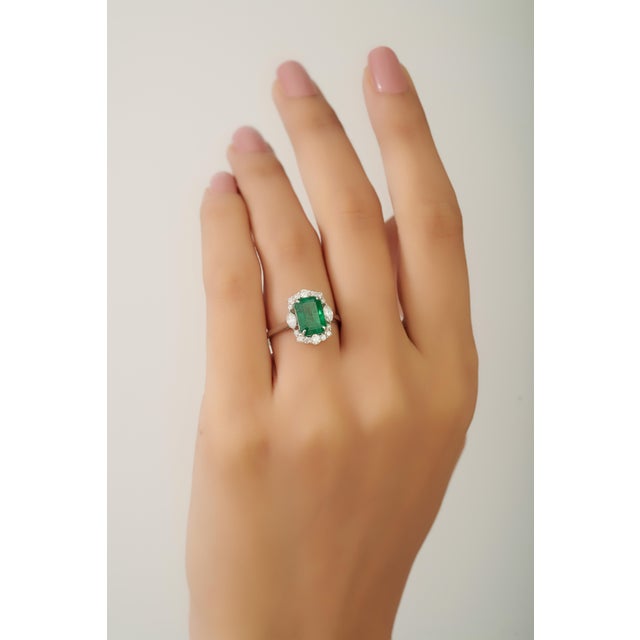 This luxurious cocktail ring features a vibrant 2.44 carat emerald Crafted in 18K white gold. The emerald measuring...