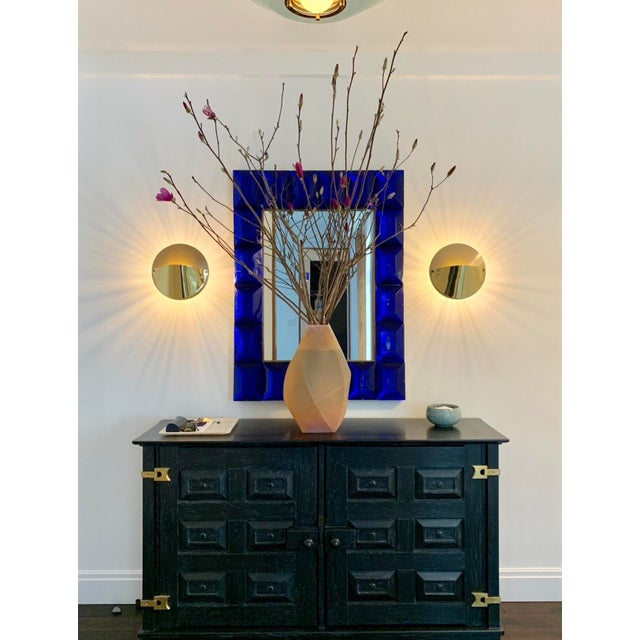 A pair of circular polished brass and matte gold lacquered sconces with radiant backlighting Produced by FLOS , Italy 1982
