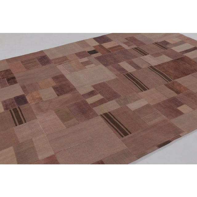 Handwoven in wool circa 1950–1960, this 7x10 vintage patchwork rug is a refined addition to Rug & Kilim’s collection. It...