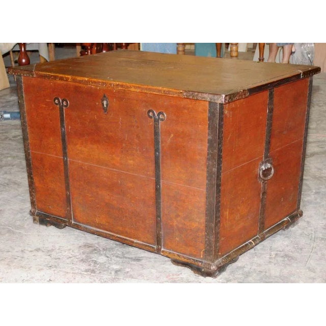 Large dowry chest with great hardware. Original paint was feather brushed for a wood grain texture. Has interior candle box.