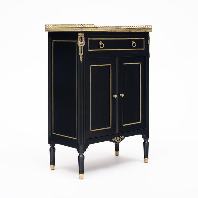 Petite cabinet from France in the Louis XVI style. This piece is made of solid wood construction, primarily mahogany. It...