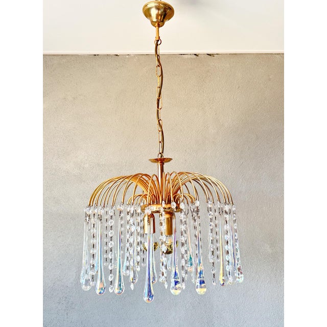 Beautiful luxury Italian chandelier. 1970s large lamp that is truly pleasing to the eye with its iridescent glass...