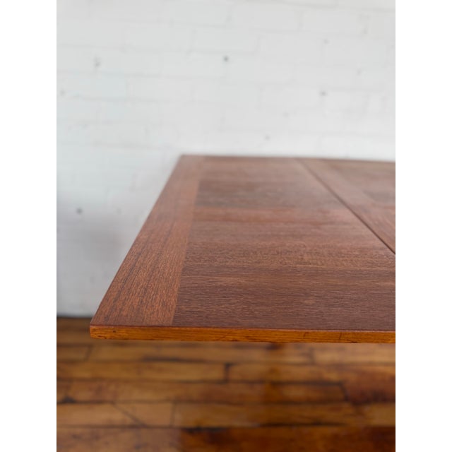 Solid teak dining table from circa 1960 Denmark. Measures 67“ X 35.25“ and 29“ tall. Leaves fold under to create card...