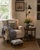 A handsome early 20th century forged iron floor lamp with a tall, slender standard, four-leg base, scrolling candle arm,...