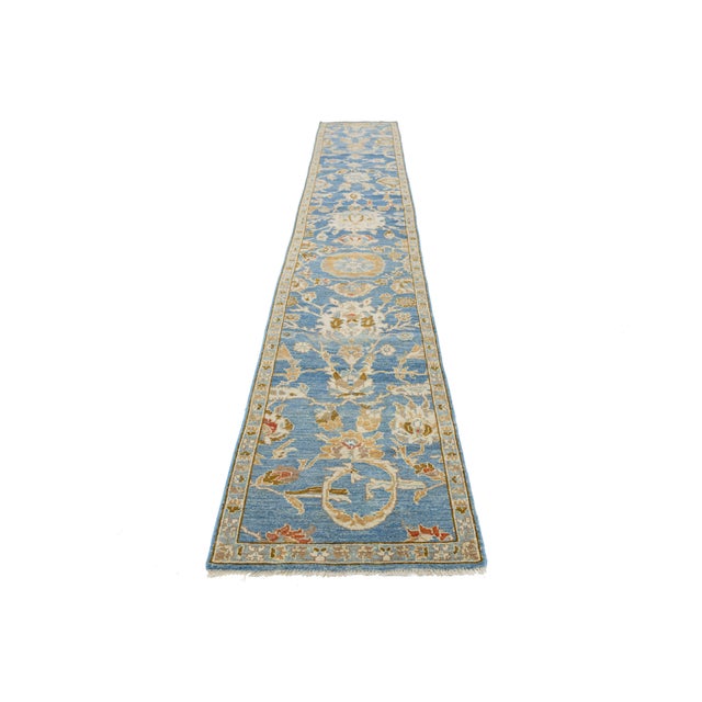 Introducing a stunning modern Sultanabad hand-knotted wool runner featuring a rich blue field. This beautifully crafted...